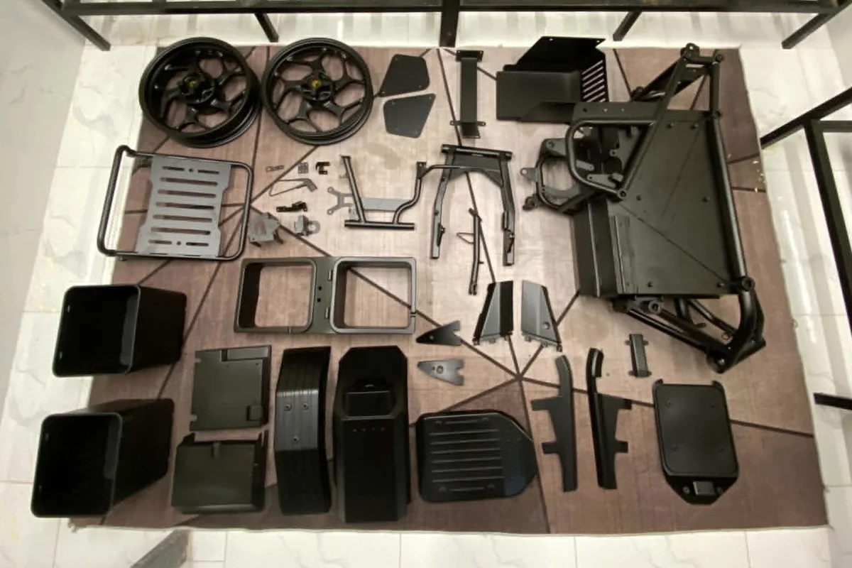 Every prototype part of the U1 laid out before assembly: wheels, frame, battery bays, racks, brackets and body panels