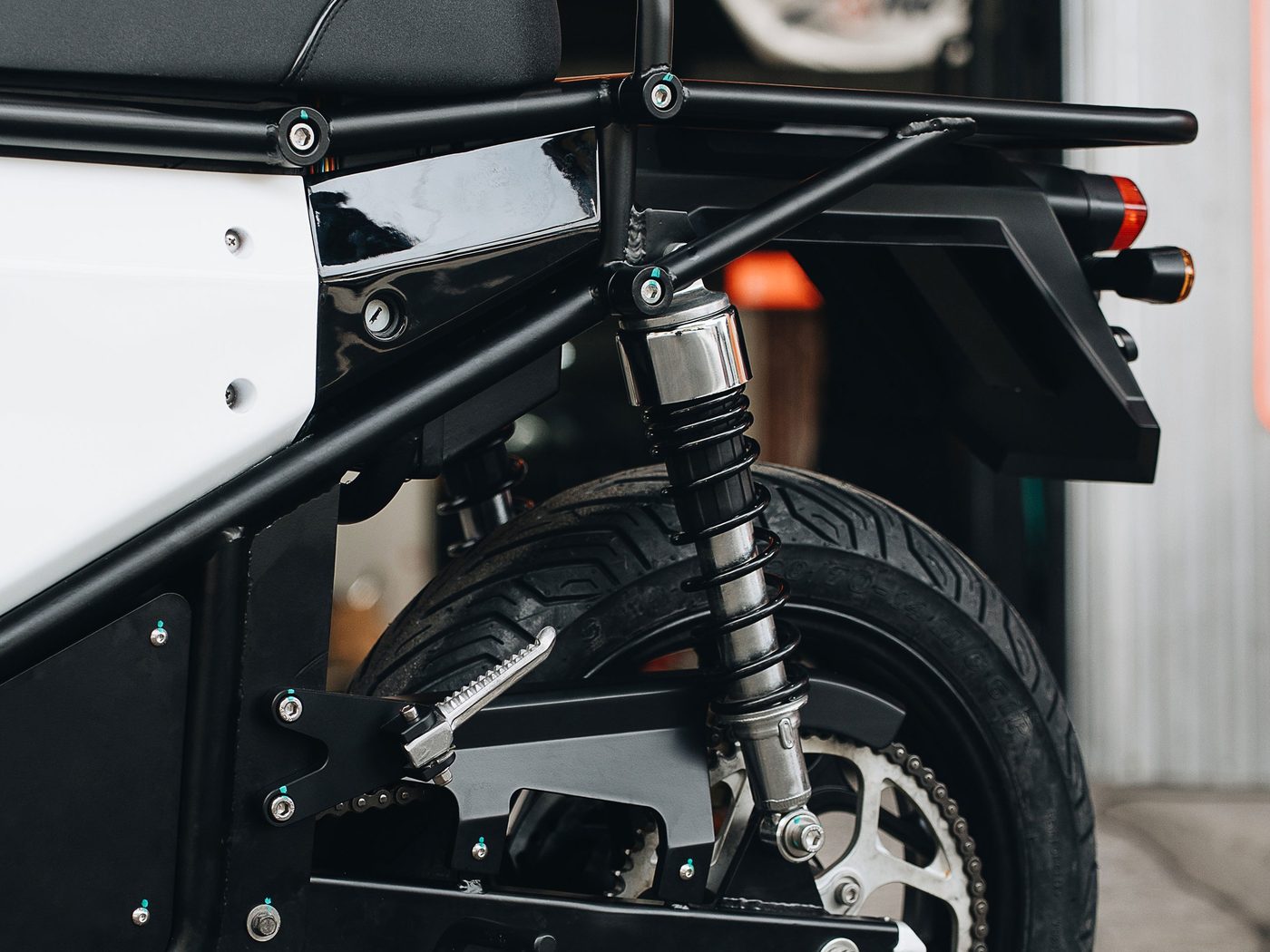 Rear suspension, chain drive, and the bolted side panel on the running prototype.
